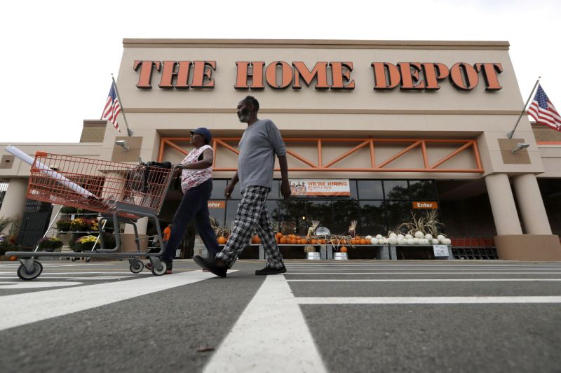In this Monday, Sept. 23, 2019 photo people depart a Home Depot store location, in Boston. (AP Photo/Steven Senne)